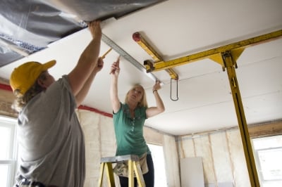 Volunteers at work on ceiling.