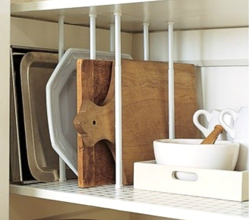 Tension rods in kitchen cabinet.