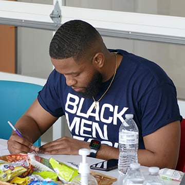 Black Men Teach signing at Habitat office.