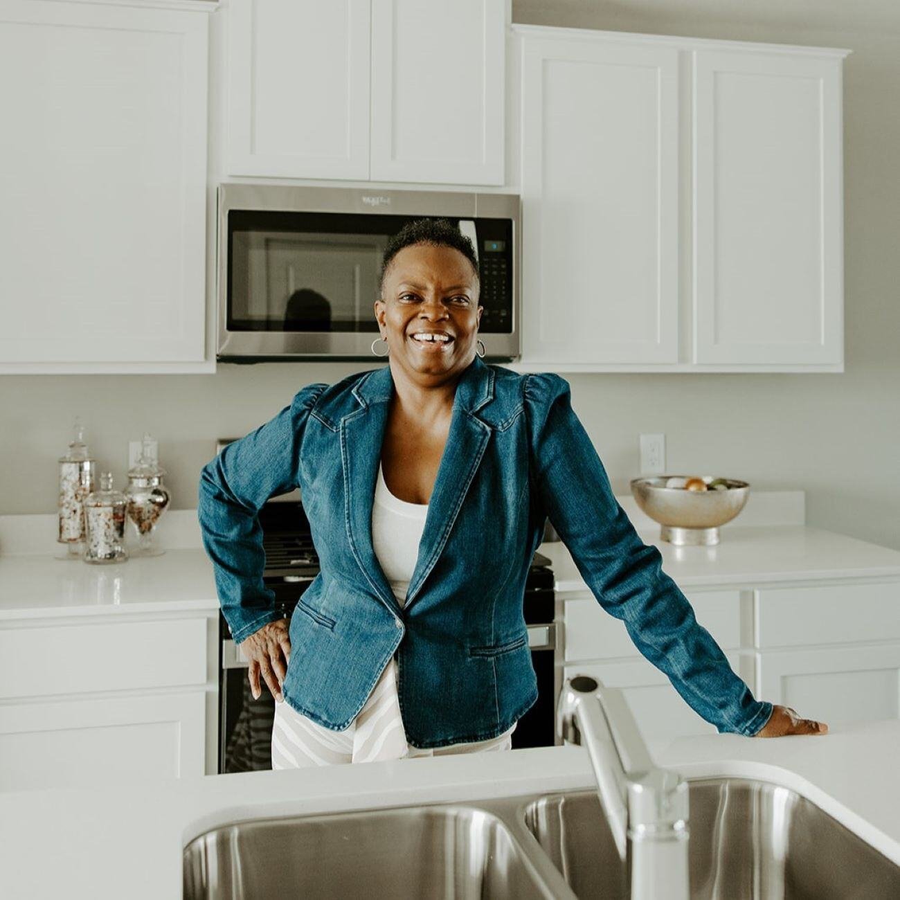 Bridgette smiling in her kitchen.