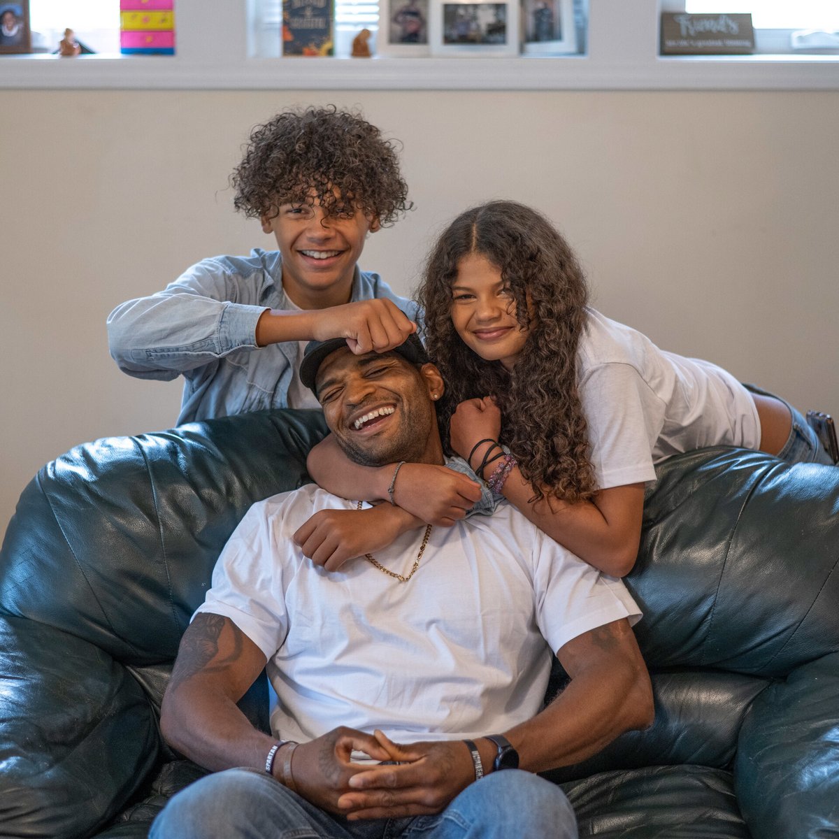 A dad poses with two children