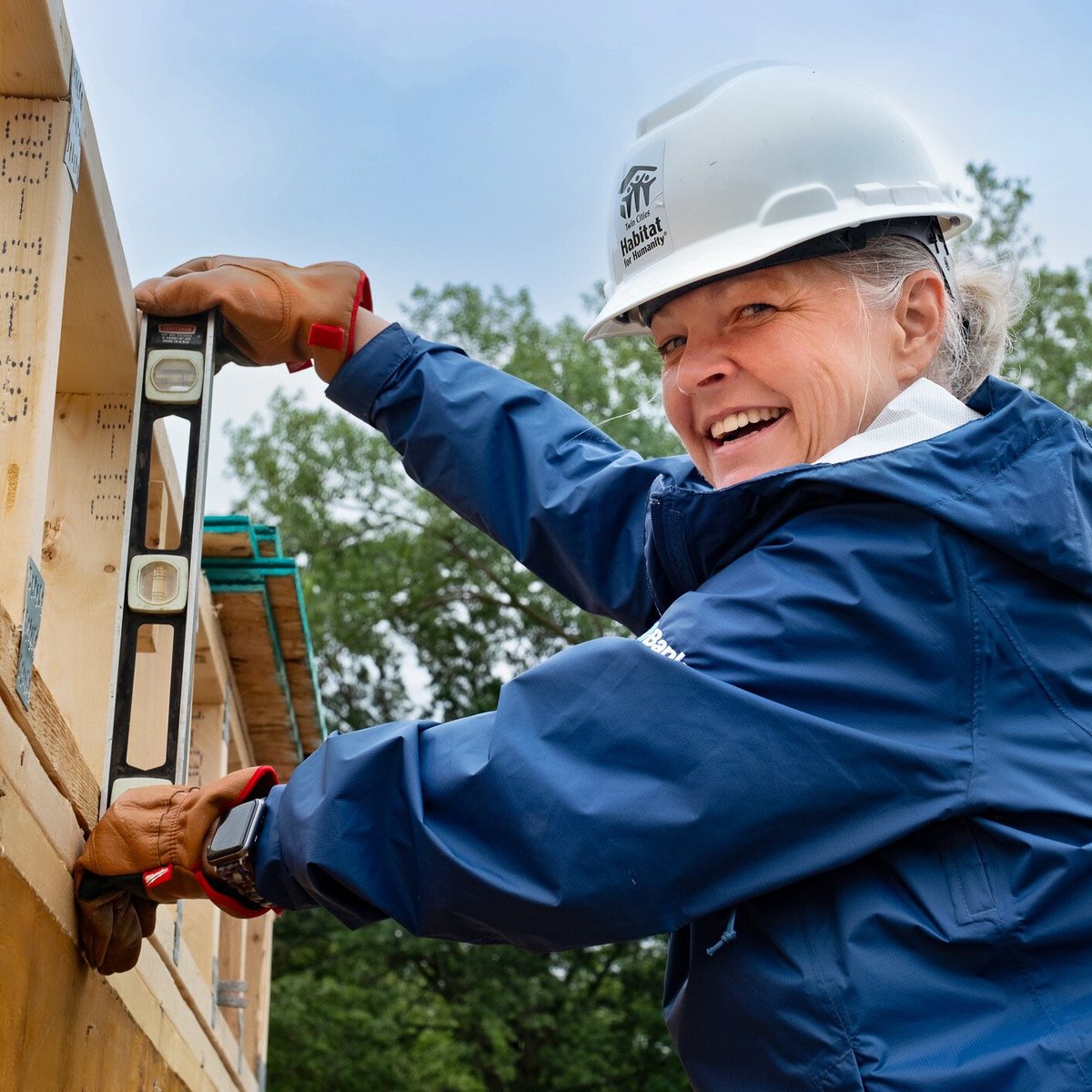 Smiling volunteer with a level